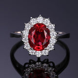 Bague classique avec rubis et bord en or blanc