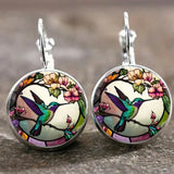Collier avec pendentif en métal en forme d'hirondelle avec dôme en verre